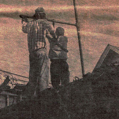 Dick Barham and Clifford Doolittle dismantle pipes after the fire, source: Mendocino Grapevine, January 13, 1977