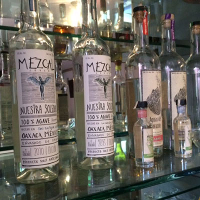 Shelf of Mezcals in La Olla Bar